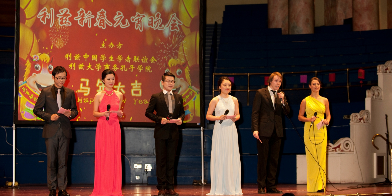 Six glamorous people on stage presenting the Chinese New Year Gala