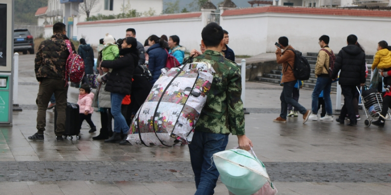 migrant worker carrying bags