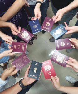 Participants holding their passports showing the range of countries they come from