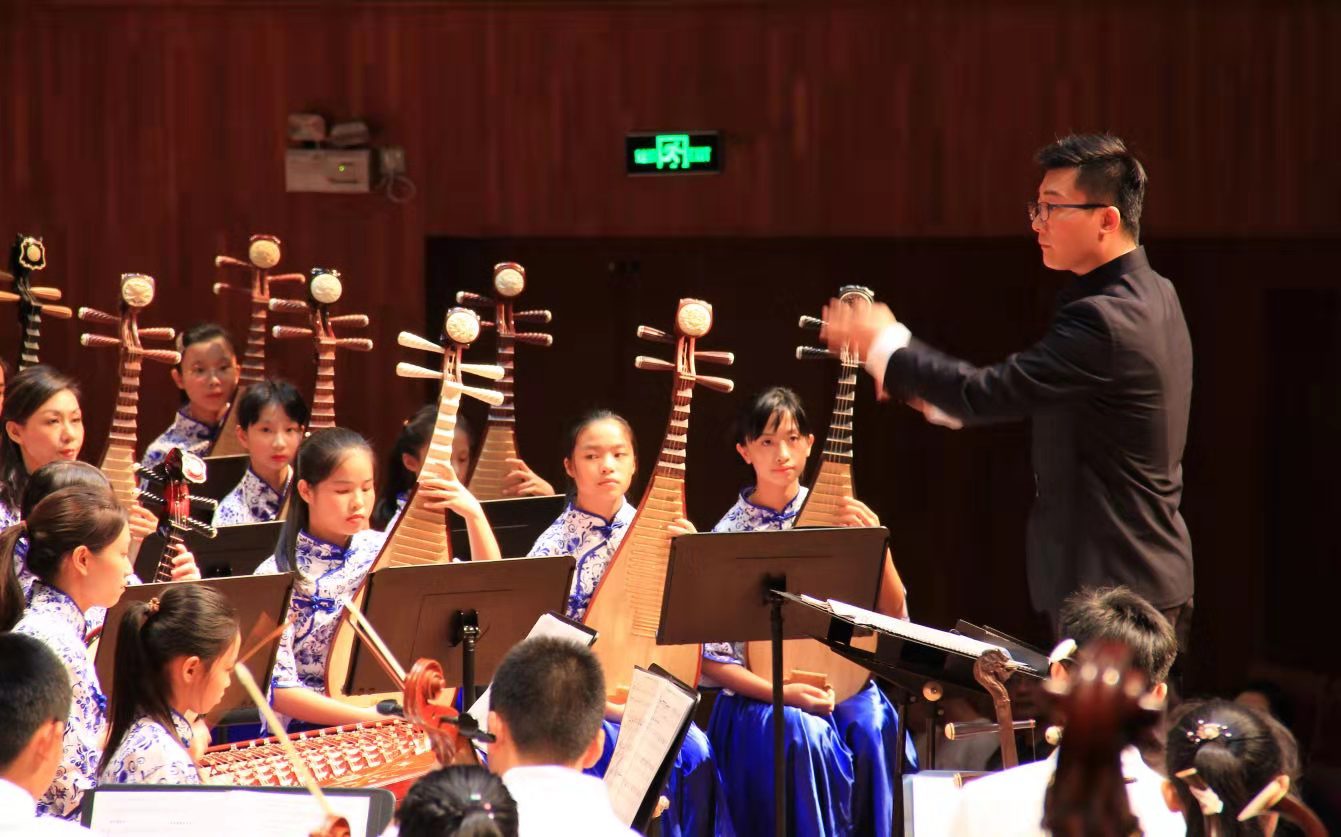 Traditional Chinese orchestra and conductor on stage performing
