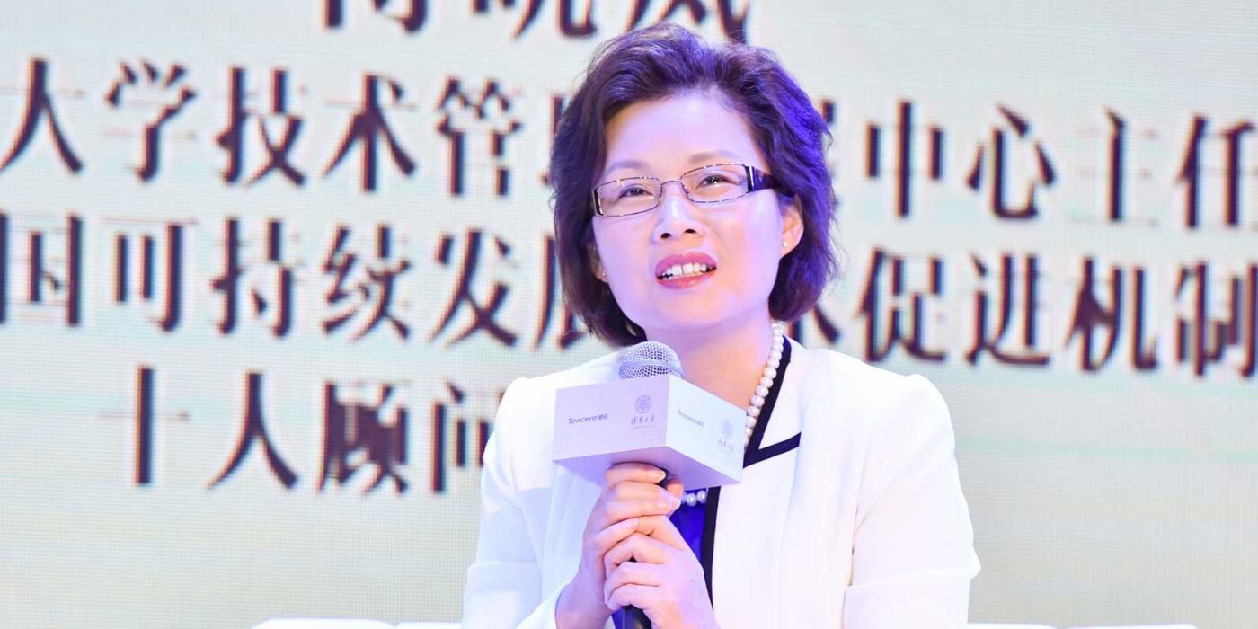 Xiaolan Fu holding a microphone