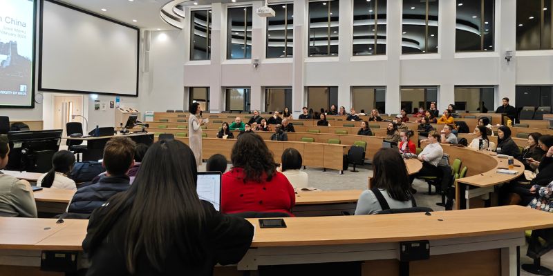 People seated in a large lecture theatre